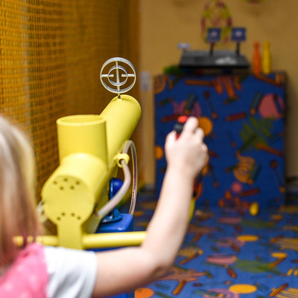 Children shoot at targets with a toy gun